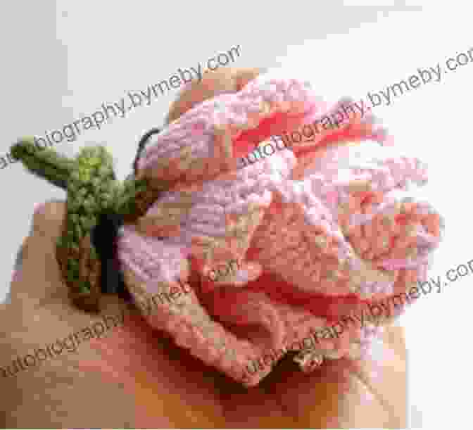 A Knitted Rosebud With Pink Petals And A Green Stem KNITTING PATTERN Knitted ORCHID Flower By Emi Harrington: Easy Knitted Flower For Embellishing All Your Knitted Projects