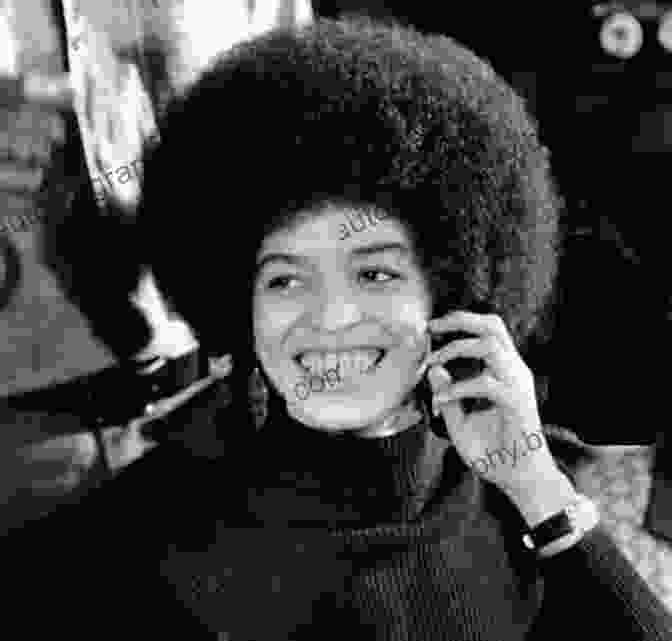 Angela Davis Smiling And Holding Her Autobiography Angela Davis: An Autobiography Angela Y Davis